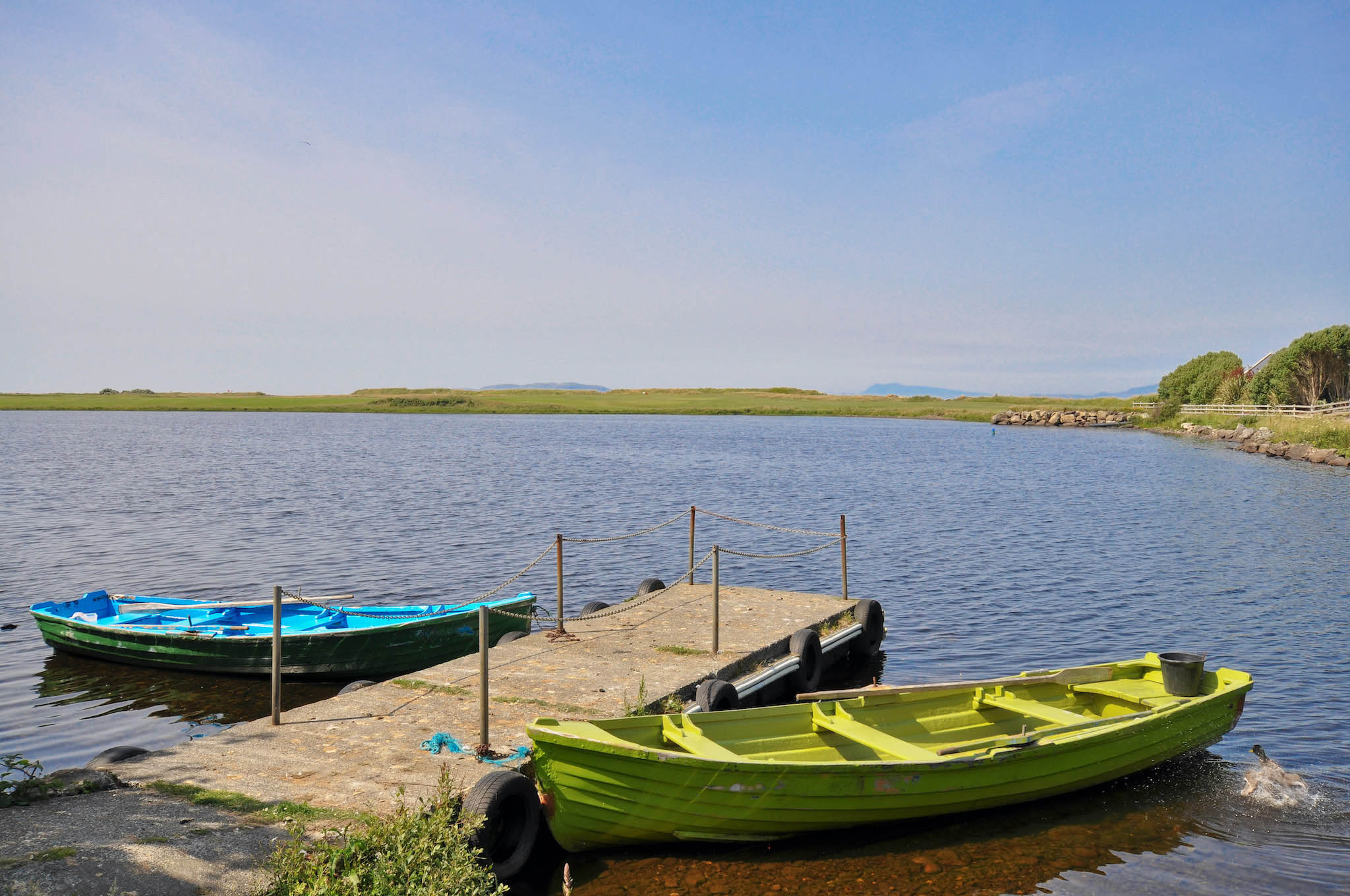 boats on a dock next to a body of water